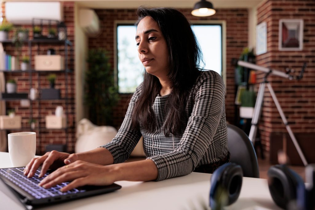 Indian woman working on laptop website